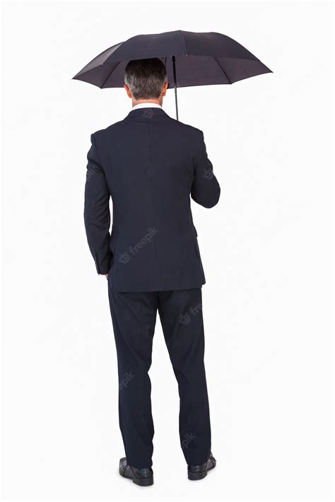 Premium Photo Rear View Of A Businessman Under Umbrella