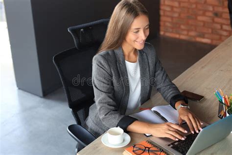 Beautiful Business Woman Working On Laptop In The Office Stock Photo