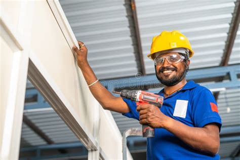 Worker Looking Camera While Fixing Using Drilling Machine Or Gun On