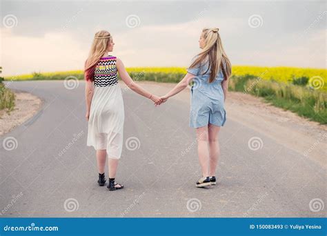 Two Girls Go On The Road Holding Hands Stock Image Image Of Girl Smile 150083493