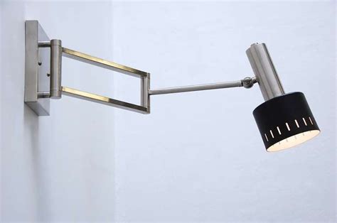 Wall plug with switch(or dimmer) and all metal variants are the centric wall sconce is a stately take on french modernism, featuring a spun metal mesh shade. Articulated Wall Sconce from Germany at 1stdibs