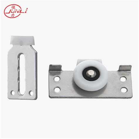 Lower roller guides in the floor track upper roller guides in the ceiling track slanted door guide in the interior system front of closet. JL-007 Furniture Cabinet Sliding Door Roller | JunLi Hardware