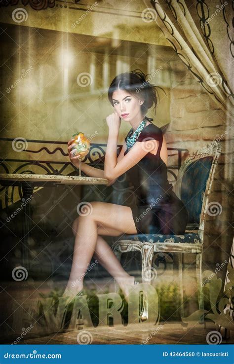 Fashionable Attractive Young Woman In Black Dress Sitting In Restaurant
