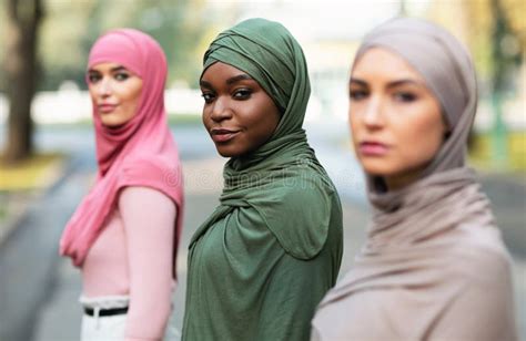 Three Diverse Millennial Ladies Wearing Hijab Posing Standing Outdoors