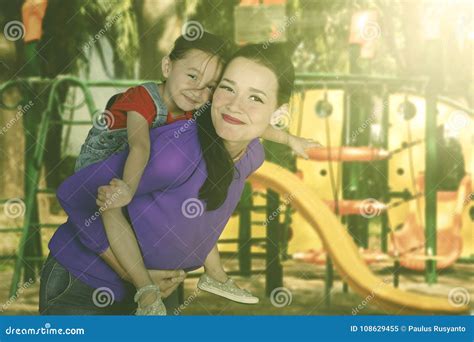 Mother Playing With Her Daughter In The Playground Stock Image Image