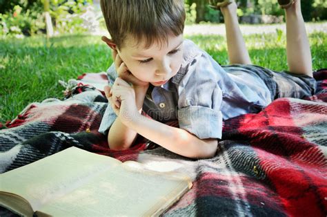 Little Boy Reading Book Lying Mat Park Stock Photos Free And Royalty
