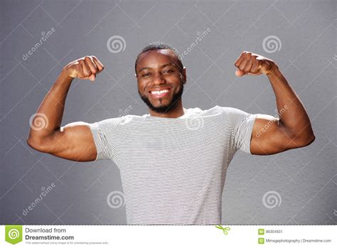 Young Smiling Man Flexing Arm Muscles Stock Image Image Of Laughing