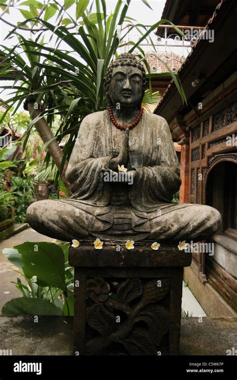 Buddha Statue Holding Glass In Garden In Bali Indonesia Stock Photo Alamy