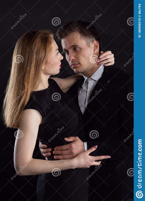 A Beautiful Young Girl Gently Embraces A Man Around The Neck Who Gently Holds Her Waist. Couple ...