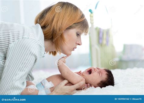 Mother Comforts Her Crying Newborn Baby Stock Photo Image Of Child
