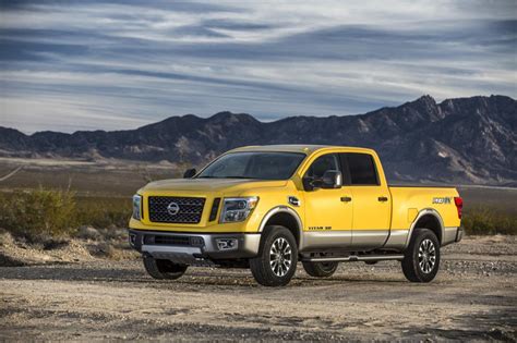The Nissan Titan Xd With Off Road Rims And Tires Rolls Into Shot
