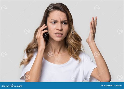 Annoyed Angry Woman Quarreling Talking On Phone Hearing Bad News Stock