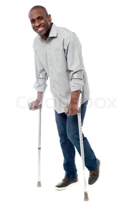 Man Walking With Crutches Isolated On A Stock Image Colourbox
