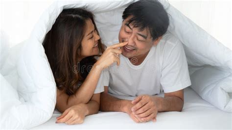 Asian Mature Couple Having Romantic Moment Together With Flowers