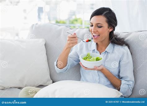 Happy Woman Relaxing On The Sofa Eating Salad Stock Image Image Of