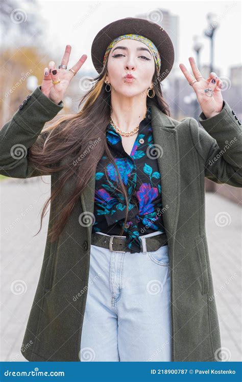 Portrait Of A Beautiful And Young Hippie Girl Who Shows The Gesture Of