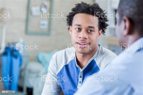 Serious African American Teenager Has Conversation With His Dad Stock
