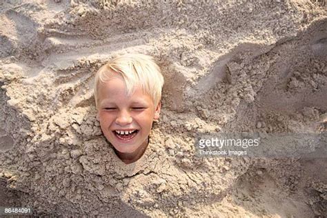 Boys Buried In Sand Photos And Premium High Res Pictures Getty Images