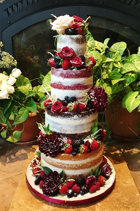 Four Tiered Naked Wedding Cake With Fresh Flowers Strawberries Blueberries Raspberries And