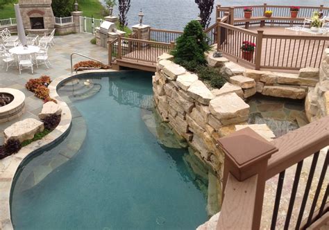 A swimming pool, swimming bath, wading pool, paddling pool, or simply pool is a structure designed to hold water to enable swimming or other leisure activities. Bolingbrook Natural Stone Pool and Landscape - Pool ...