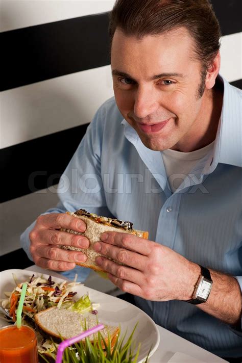 Man Eating Sandwich In A Restaurant Stock Image Colourbox