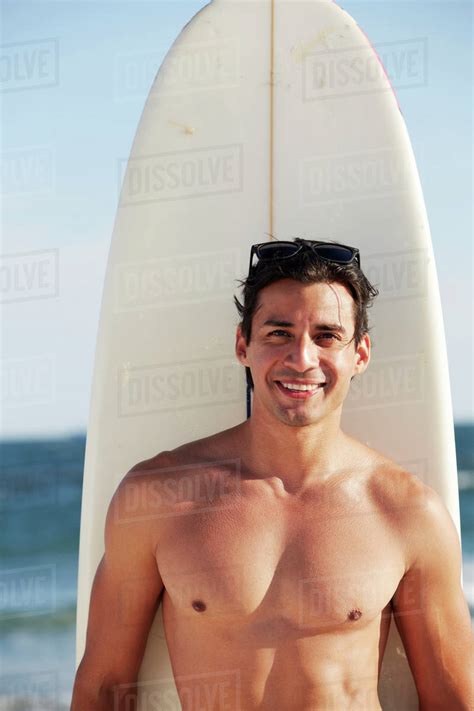 Smiling Man With Surfboard On Beach Stock Photo Dissolve