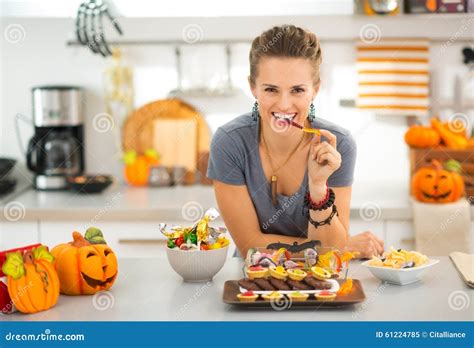 Smiling Woman Eating Trick Or Treat Halloween Candy Stock Image Image
