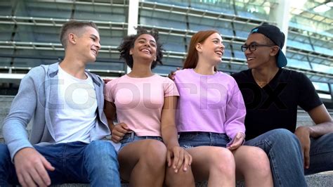 Multi Racial Group Young People Hugging Sitting Outdoors Friendship