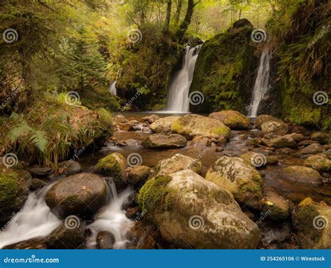 Long Exposure Shot Of Powerscourt Waterfall On Mossy Rocks In Ireland