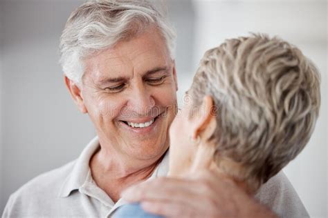 Senior Couple Retirement And Man Hug Woman At Home For Love Care And