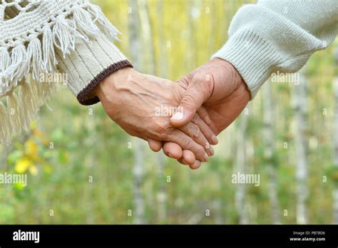 Elderly Couple Holding Hands Stock Photo Alamy