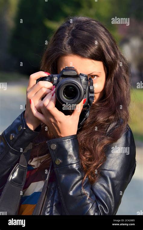 Portrait Of Young Lady Photographer Using Dslr Camera In Nature