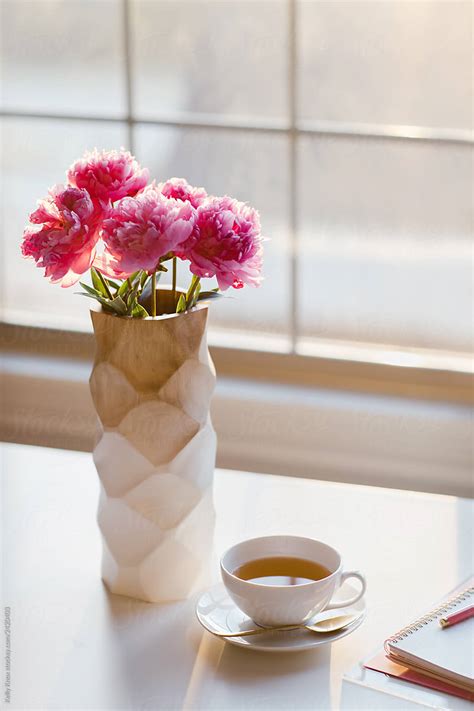 Vase Of Peonies With Cup Of Tea In Morning Light By Stocksy