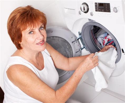 Woman Puts Clothes In The Washing Machine Stock Photo Image Of Adult