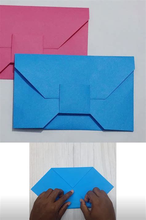Someone Is Making An Origami Envelope Out Of Blue Paper And Pink