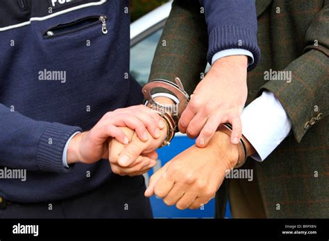 Police officer with handcuffs, arresting a suspect Stock Photo - Alamy