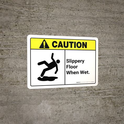 caution slippery floor when wet with graphic ansi wall sign