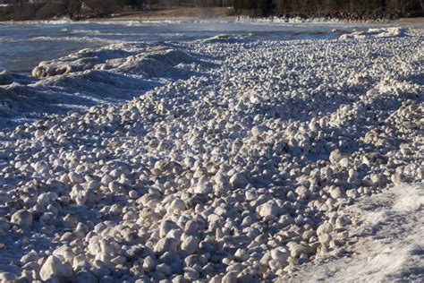 Snow Frost And Wind Create Irregularly Shaped Ice Balls On The Shores