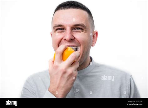 Man Eating An Orange With Face Expression Stock Photo Alamy