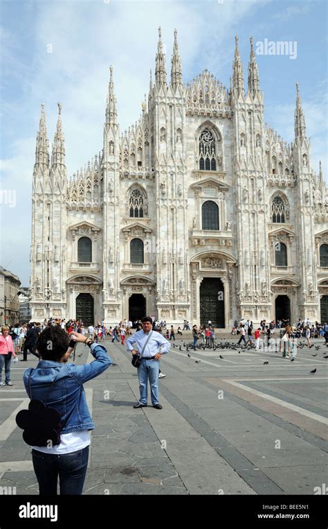 Woman Photographing Her Husband Partner In Front Of Il Duomo Di Milano