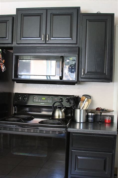 A massive blue, dark gray and white tile backsplash i think makes. black cabinets with black appliances - Google Search ...