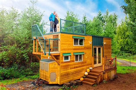 The exterior has a combination of shake siding, wood beams, and large windows giving it great curb appeal. DIY Tiny House With Rooftop Deck | Basecamp | Country Froot