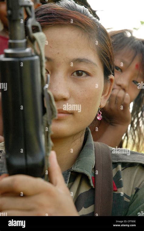 nov 29 2006 sarlahi nepal a village girl watches the female fighters of nepal s maoist