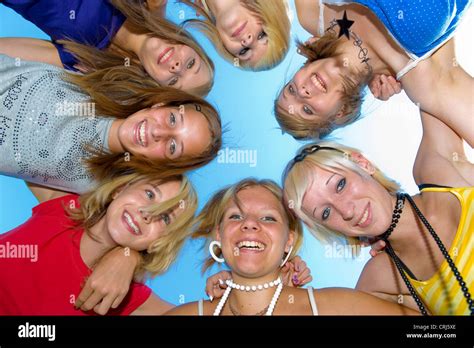 7 Teenage Girls In A Circle Holding Eachother By The Shoulders Putting