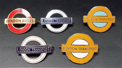 Four London Transport Enamel Cap Badges Together With A London Buses