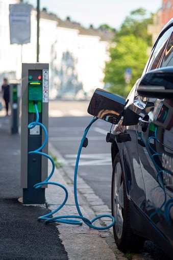 Electric Car Charging Vehicle Connected To A Power Outlet Stock Photo