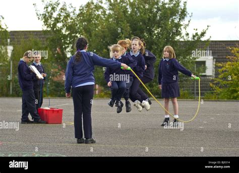 Skipping Traditional Playground Game Being Played On The Schoolyard Of A Primary School In