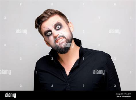 Undead Makeup For October 31 On A Bearded Man Who Shows Teeth Stock