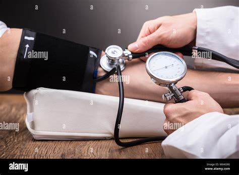 Doctor Checking Patients Blood Pressure Hi Res Stock Photography And