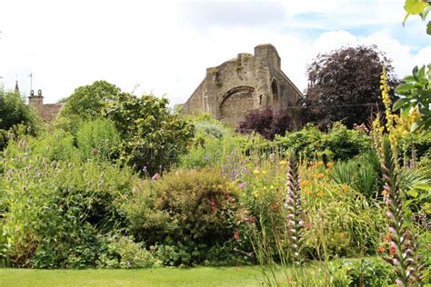 Malmesbury Abbey Ruins Seen From Abbey House Gardens Uk Stock Image